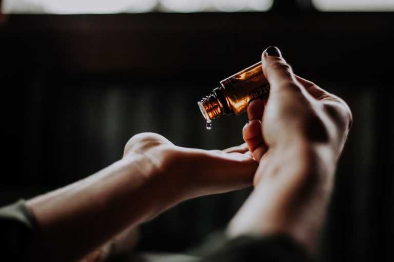 cbd oil dripping onto hand